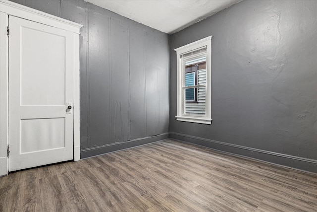 empty room with wood-type flooring