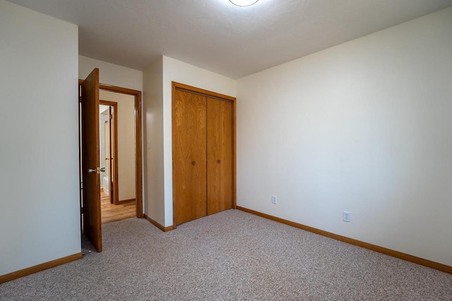 unfurnished bedroom featuring carpet flooring and a closet