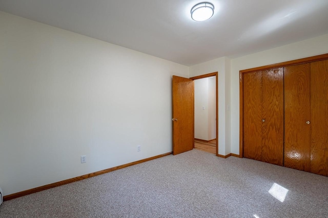 unfurnished bedroom featuring a closet and carpet floors