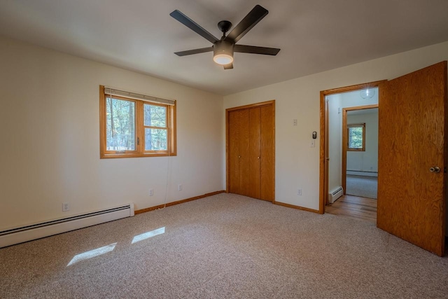 unfurnished room with a baseboard heating unit, ceiling fan, and carpet floors