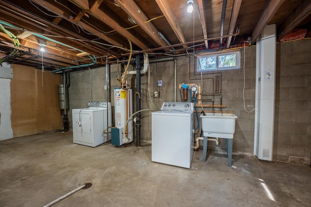 basement featuring independent washer and dryer, water heater, and sink