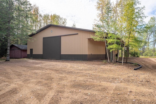 view of property exterior with an outdoor structure and a garage