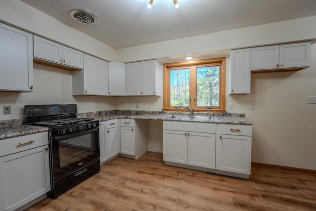 kitchen featuring light stone counters, sink, white cabinetry, black range with gas cooktop, and light hardwood / wood-style flooring