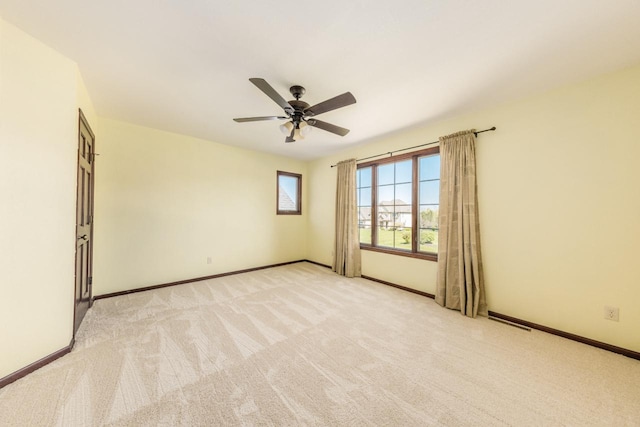 spare room with carpet floors and ceiling fan