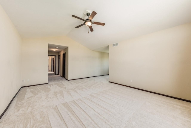 carpeted spare room with vaulted ceiling and ceiling fan