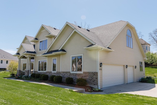 view of front of property featuring a front lawn and a garage