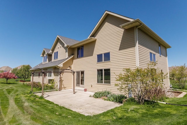 rear view of house with a patio area and a yard