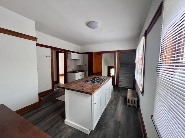 kitchen featuring wooden counters, radiator heating unit, white cabinetry, and dark wood-type flooring