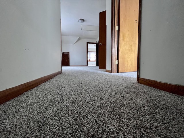 unfurnished room with carpet and vaulted ceiling