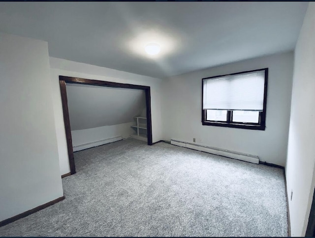 unfurnished bedroom featuring carpet floors and baseboard heating