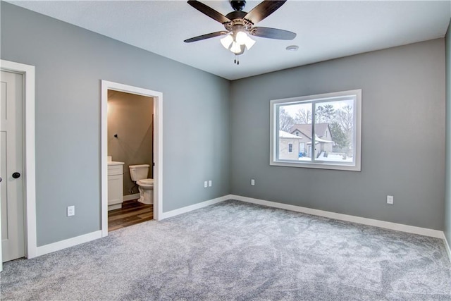 unfurnished bedroom featuring carpet floors, ceiling fan, and ensuite bathroom