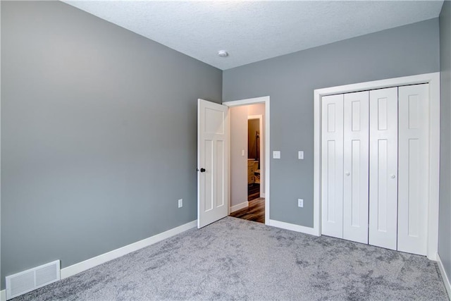 unfurnished bedroom featuring a closet and carpet flooring