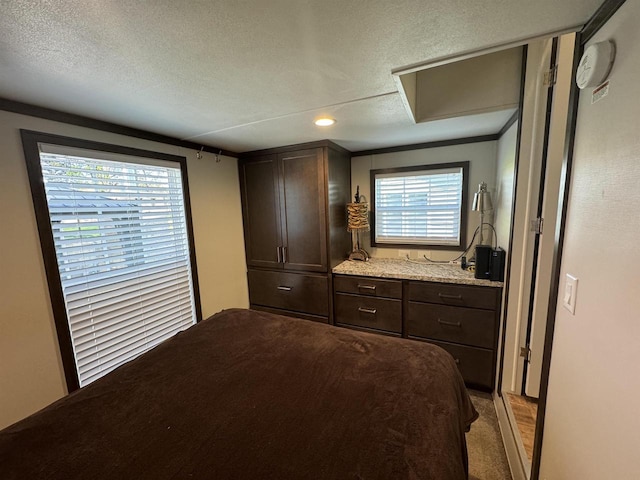 bedroom featuring light carpet and a textured ceiling