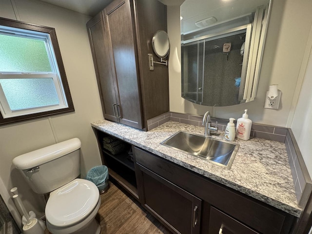 bathroom featuring hardwood / wood-style floors, vanity, and toilet