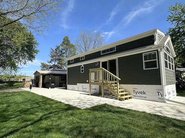 back of property featuring a gazebo, a patio, and a lawn