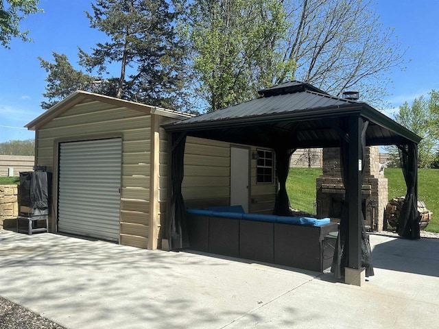 exterior space with a garage and a gazebo