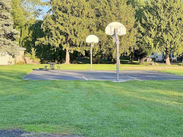 view of basketball court featuring a yard