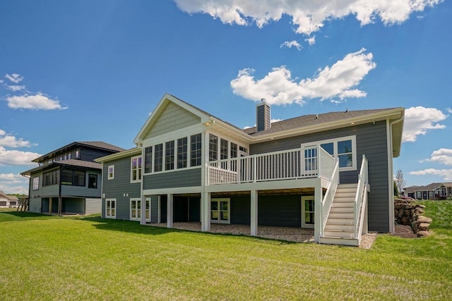 back of property featuring a yard and a wooden deck