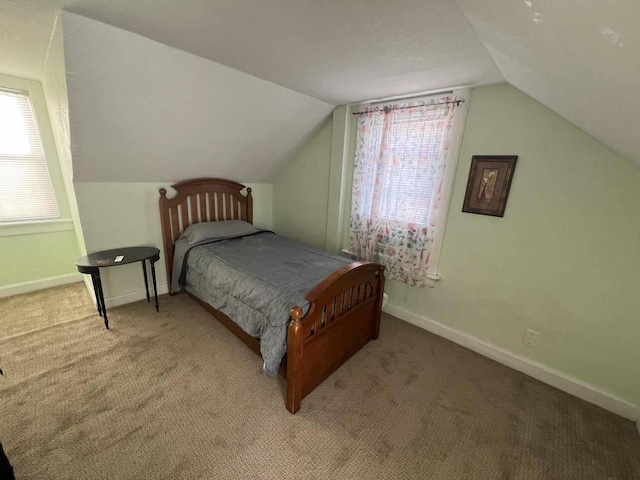 bedroom with vaulted ceiling and carpet flooring