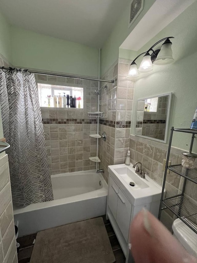 bathroom with shower / bath combination with curtain and vanity