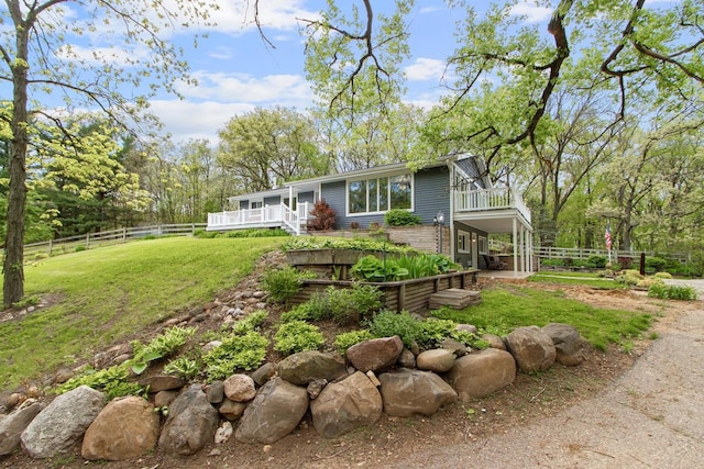 exterior space featuring a yard and a balcony