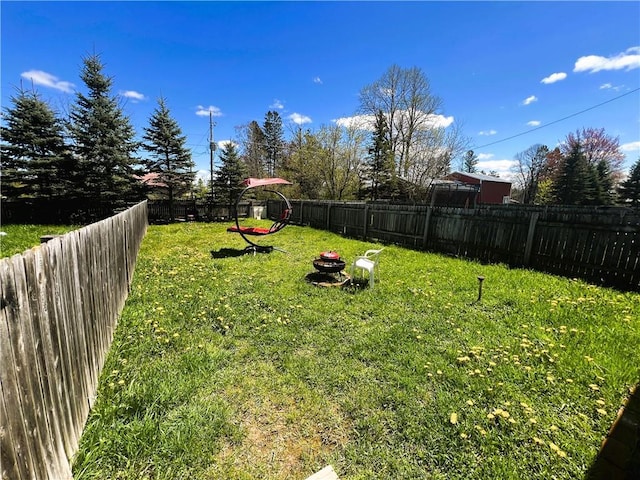 view of yard featuring an outdoor fire pit