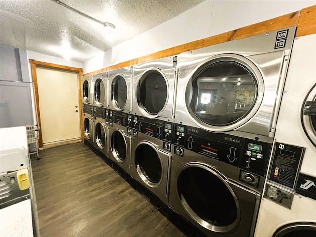 laundry room featuring a textured ceiling, stacked washer and clothes dryer, dark hardwood / wood-style flooring, and washer and clothes dryer