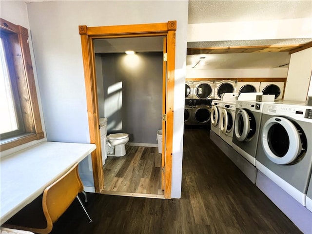 washroom featuring independent washer and dryer, dark hardwood / wood-style flooring, and a textured ceiling