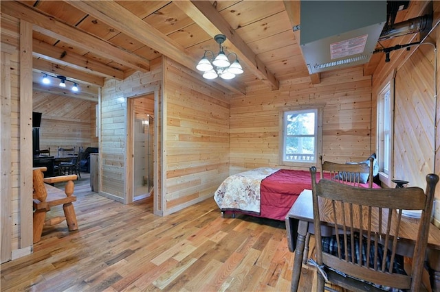 bedroom featuring wood walls, wood-type flooring, beamed ceiling, wooden ceiling, and an inviting chandelier