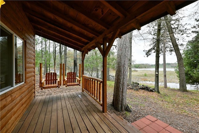 wooden deck featuring a water view