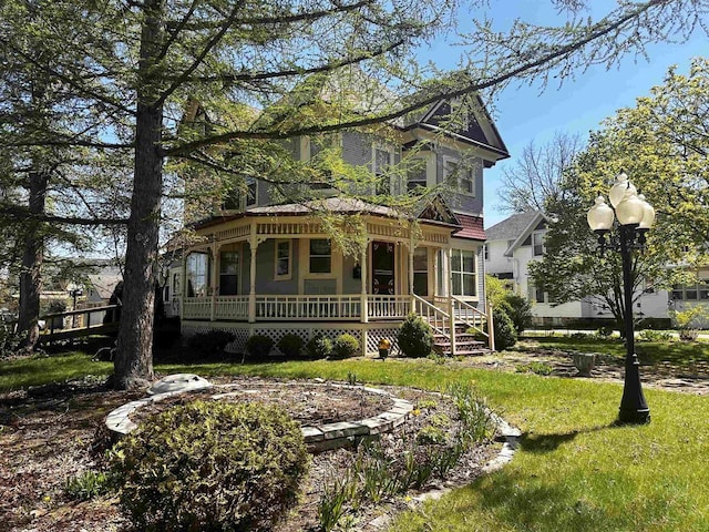 victorian-style house with covered porch and a front lawn