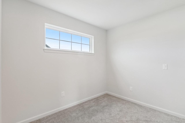 unfurnished room with light carpet