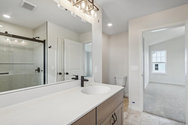 bathroom featuring tile patterned floors, a shower with door, vanity, and toilet