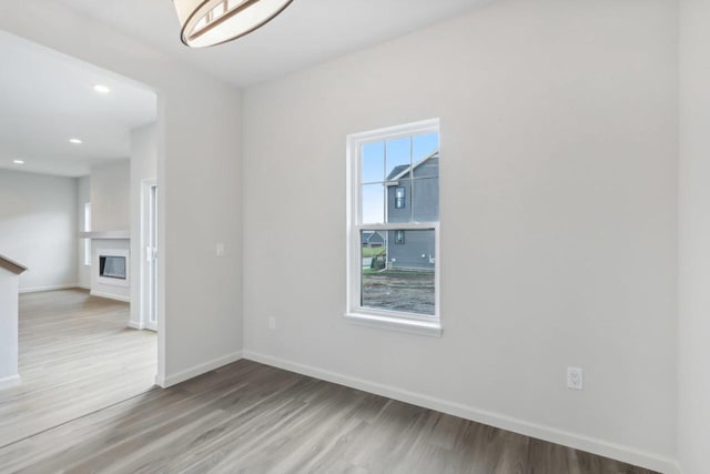 unfurnished room with light hardwood / wood-style floors