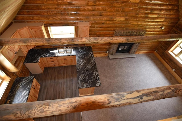 carpeted living room featuring log walls