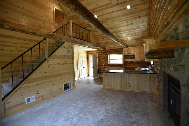 kitchen featuring light brown cabinets, wooden ceiling, carpet, and a fireplace