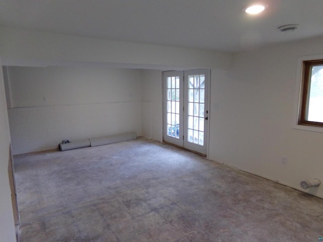 unfurnished room featuring a healthy amount of sunlight and concrete floors