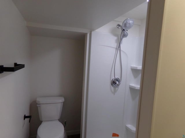 bathroom with walk in shower and toilet