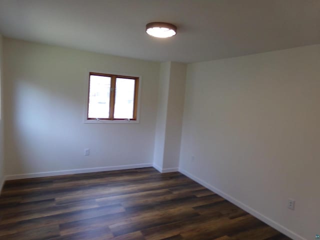 spare room featuring dark hardwood / wood-style floors