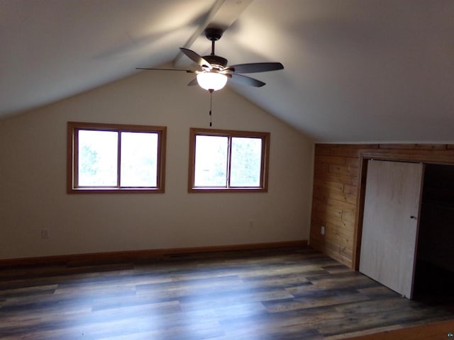 additional living space with ceiling fan, vaulted ceiling, and dark hardwood / wood-style flooring