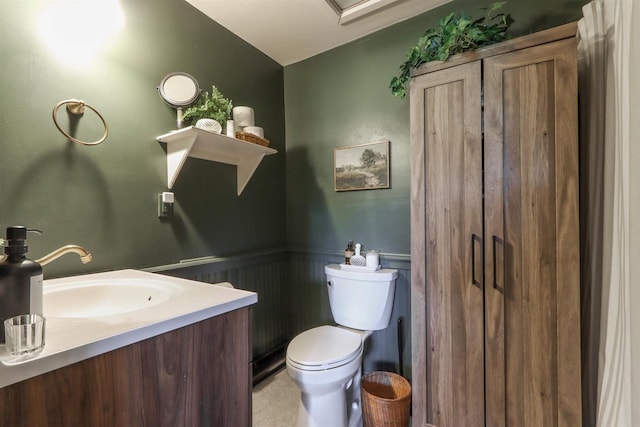 bathroom featuring tile floors, toilet, and vanity