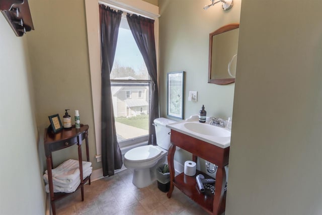 bathroom with tile flooring, sink, and toilet