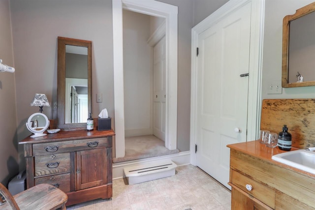 bathroom with tile flooring and vanity