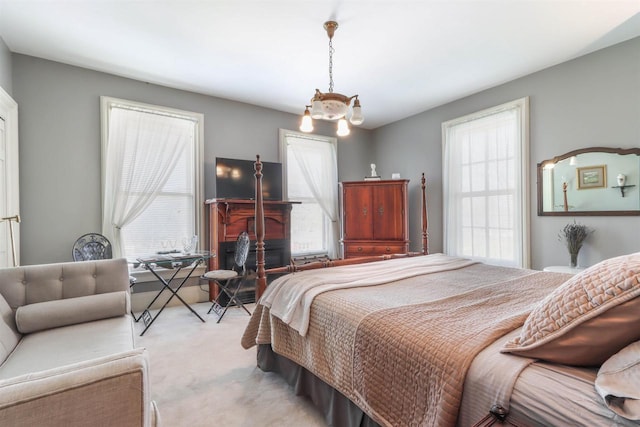 carpeted bedroom featuring multiple windows