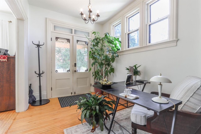 foyer featuring a chandelier, french doors, and hardwood / wood-style floors