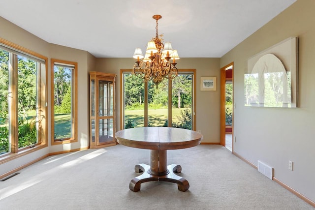 unfurnished dining area with a wealth of natural light, a chandelier, and carpet flooring