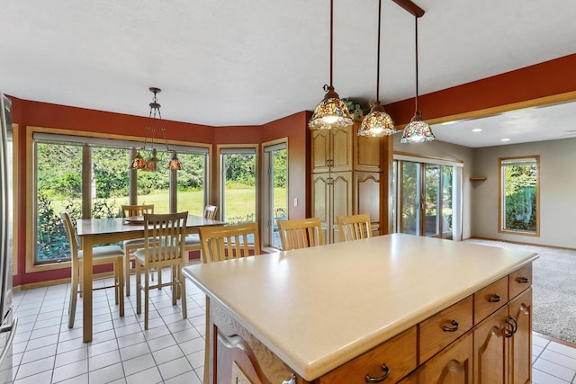 kitchen with a healthy amount of sunlight, a center island, and hanging light fixtures