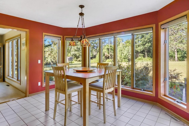 unfurnished dining area featuring light tile patterned floors and a wealth of natural light