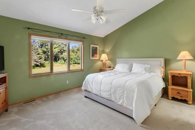 bedroom with lofted ceiling, light colored carpet, and ceiling fan