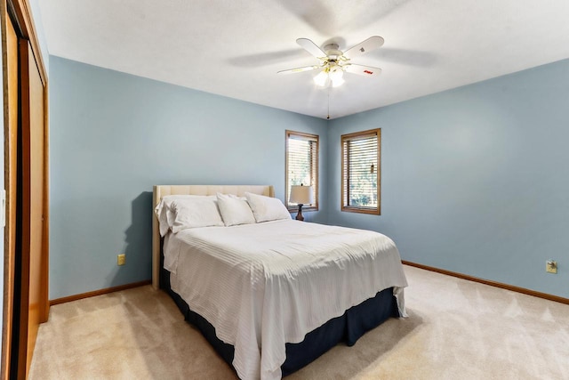 bedroom featuring a closet, ceiling fan, and light colored carpet